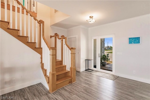 entrance foyer with ornamental molding and dark hardwood / wood-style floors