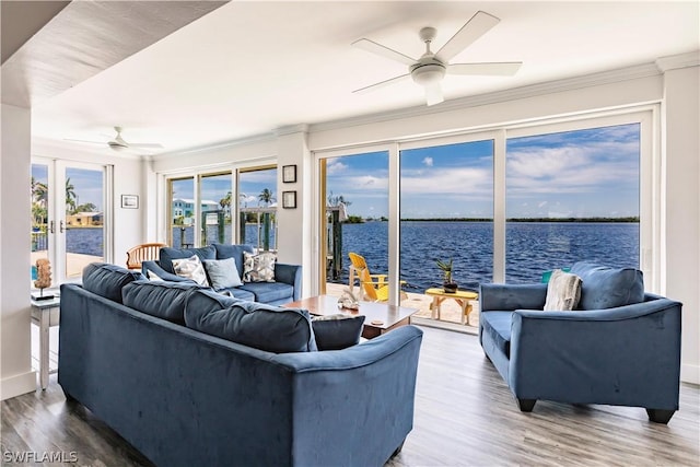 living room with a water view, ceiling fan, and hardwood / wood-style flooring