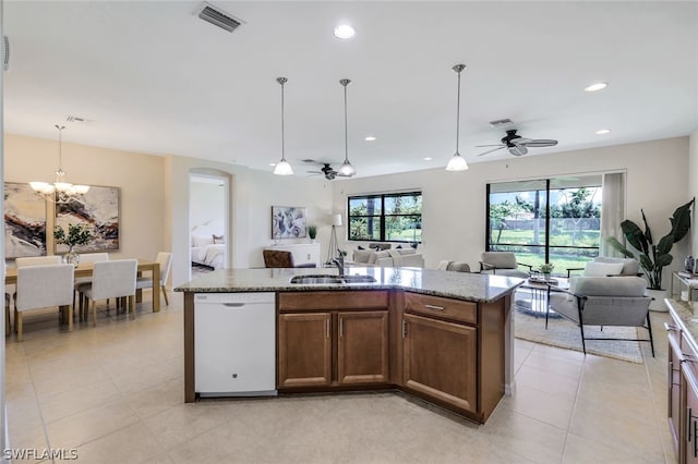 kitchen featuring a kitchen island with sink, white dishwasher, and ceiling fan with notable chandelier