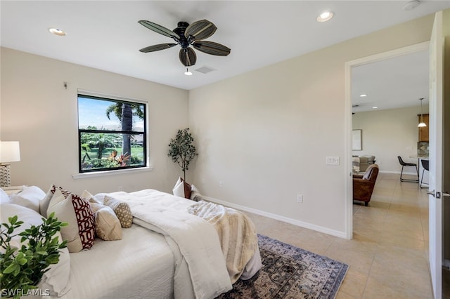 tiled bedroom featuring ceiling fan