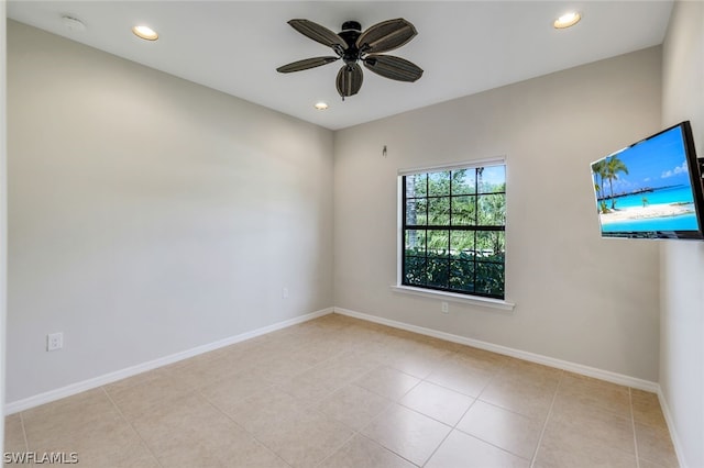 spare room featuring light tile patterned floors and ceiling fan