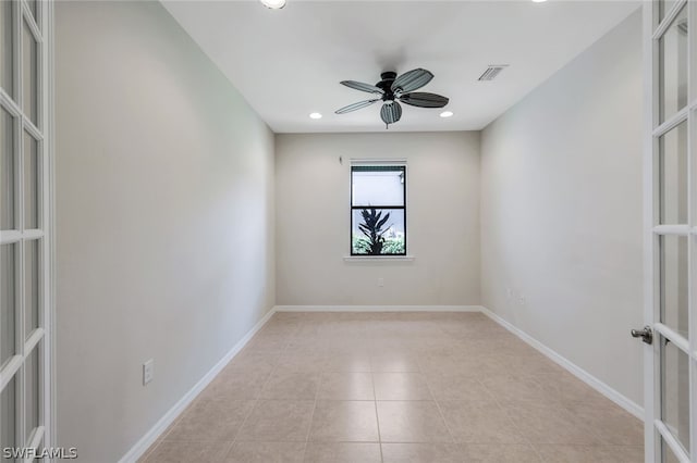 empty room featuring ceiling fan, light tile patterned flooring, and french doors