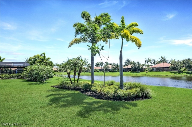 view of property's community featuring a yard and a water view