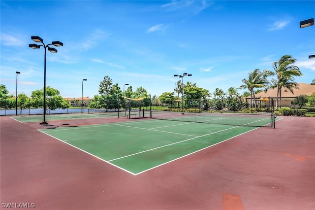 view of tennis court with basketball hoop