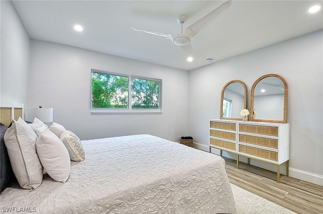 bedroom with ceiling fan and light hardwood / wood-style flooring