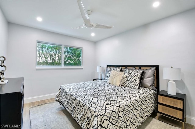 bedroom with light hardwood / wood-style flooring and ceiling fan