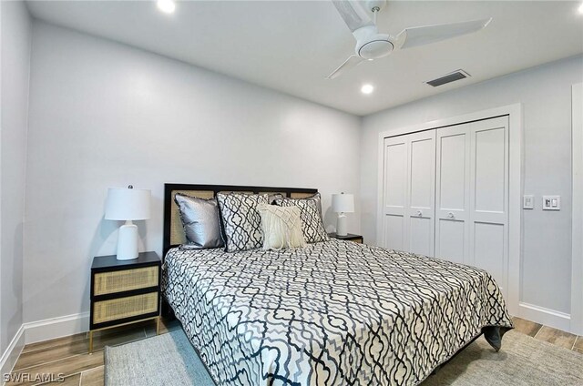 bedroom with ceiling fan and a closet