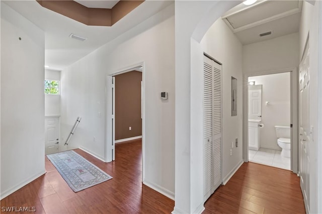 hallway featuring hardwood / wood-style flooring and electric panel