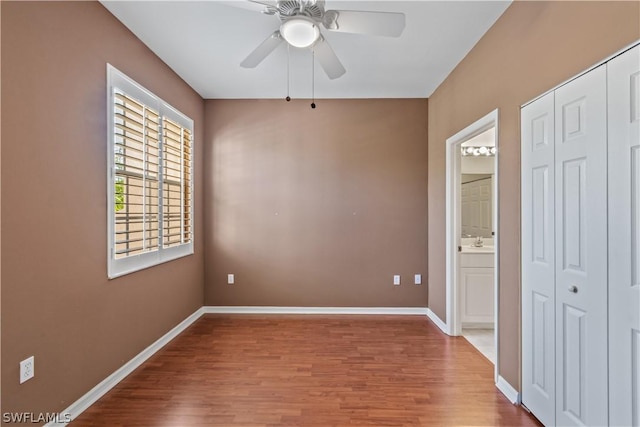 spare room featuring sink, hardwood / wood-style flooring, and ceiling fan