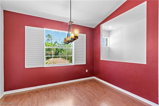 unfurnished dining area featuring hardwood / wood-style floors and a chandelier