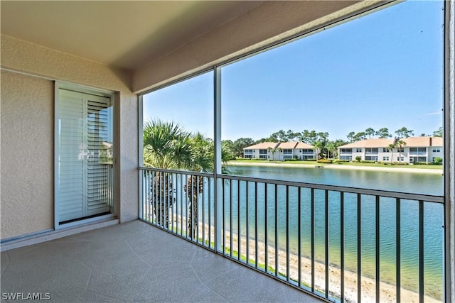 unfurnished sunroom featuring a water view