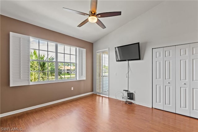 unfurnished bedroom with light hardwood / wood-style flooring, ceiling fan, vaulted ceiling, access to outside, and a closet