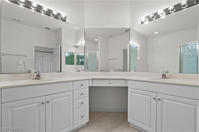 bathroom featuring tile patterned floors, an enclosed shower, and vanity