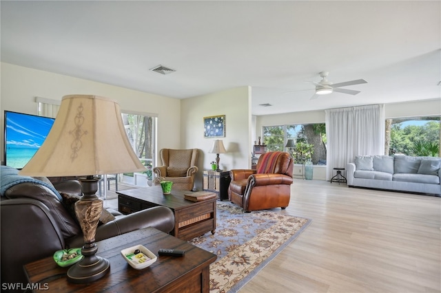 living room with ceiling fan, light hardwood / wood-style floors, and plenty of natural light