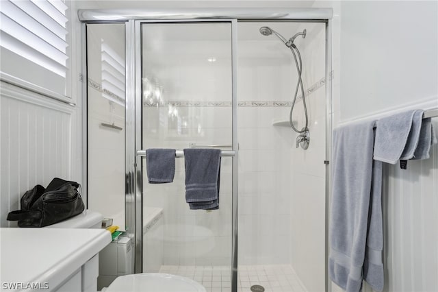 bathroom with an enclosed shower and toilet