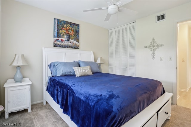 carpeted bedroom with ceiling fan and a closet