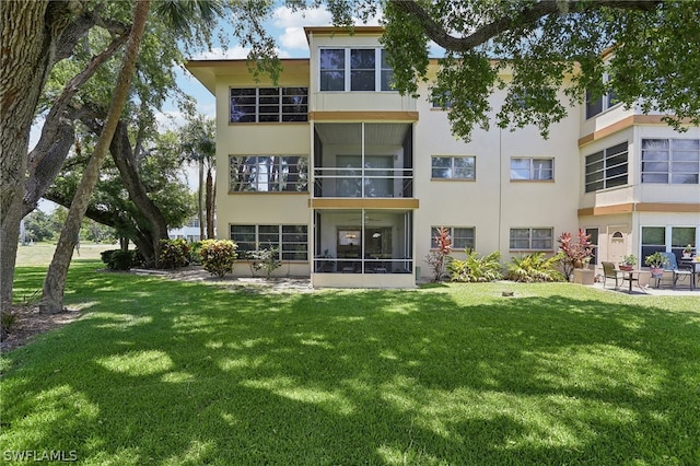 rear view of property with a yard