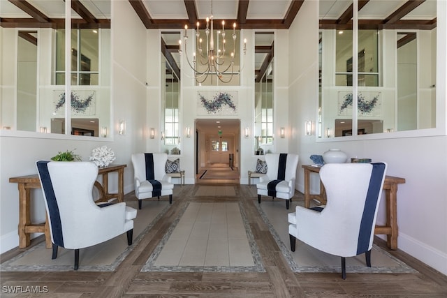 interior space with a notable chandelier, dark hardwood / wood-style flooring, and a high ceiling