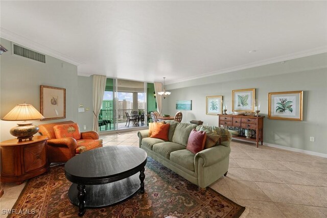 living room featuring ornamental molding, a chandelier, light tile patterned floors, and baseboards