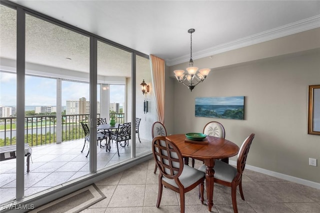 dining area featuring ornamental molding, a chandelier, light tile patterned flooring, baseboards, and a city view