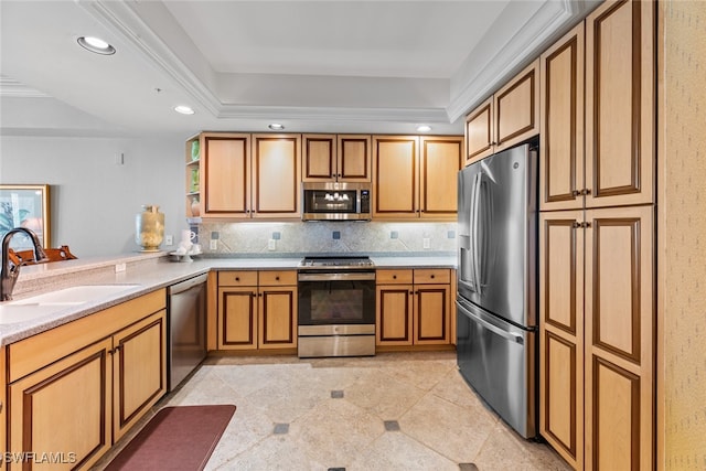 kitchen featuring appliances with stainless steel finishes, sink, decorative backsplash, light tile patterned flooring, and a tray ceiling