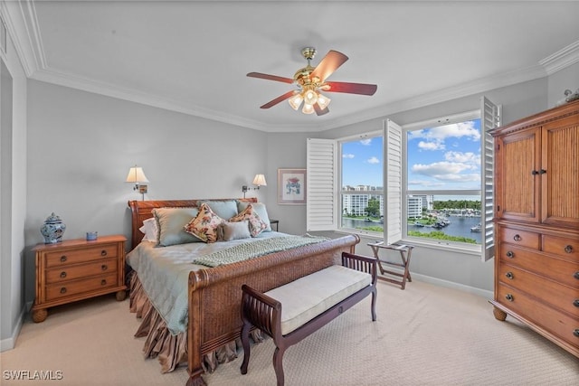 bedroom featuring light carpet, ornamental molding, baseboards, a ceiling fan, and a water view