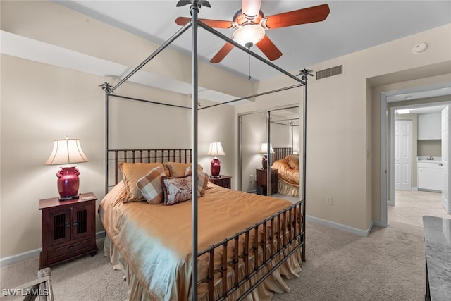 bedroom featuring light colored carpet, a closet, and ceiling fan