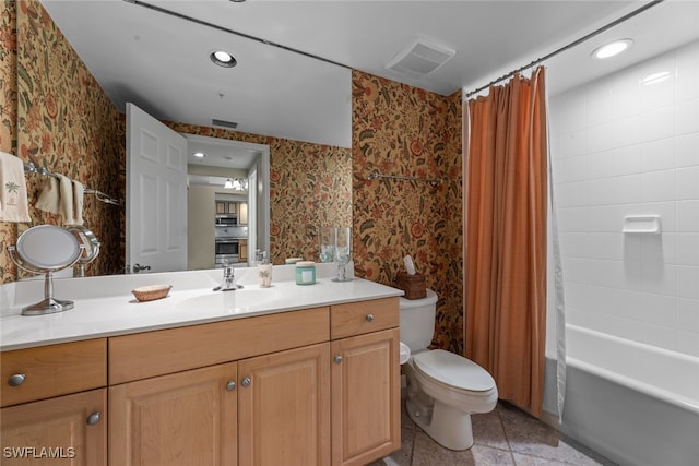 full bathroom featuring tile patterned flooring, shower / bath combo, toilet, and vanity