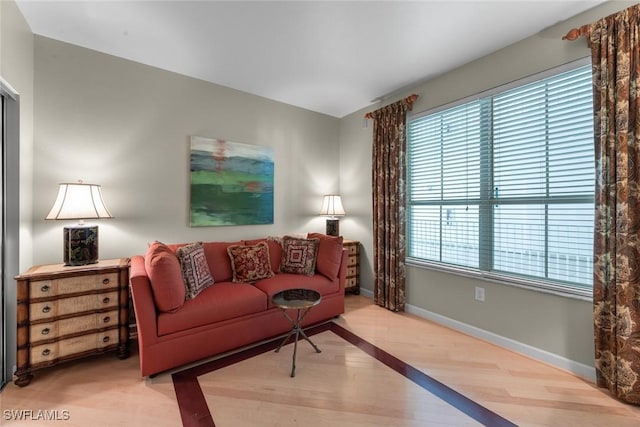 living area with wood finished floors and baseboards