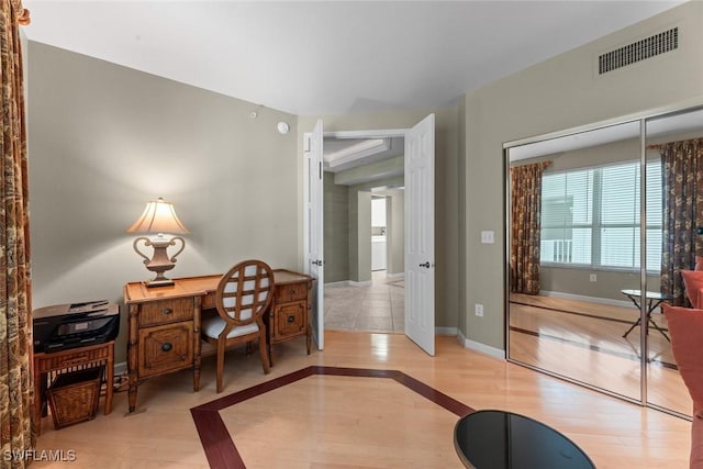 office space with wood finished floors and baseboards