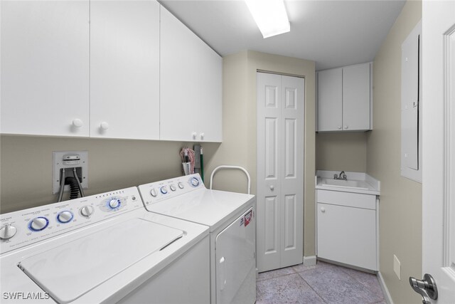 laundry area featuring sink, cabinets, washer and dryer, and light tile patterned flooring