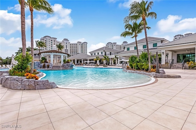 view of swimming pool featuring pool water feature and a patio area