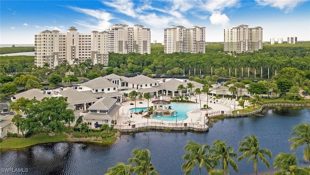 drone / aerial view of a pool and a large body of water