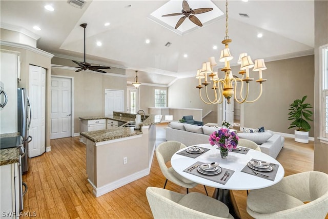 kitchen with lofted ceiling, sink, and ceiling fan with notable chandelier