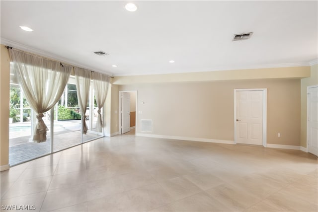 empty room featuring crown molding