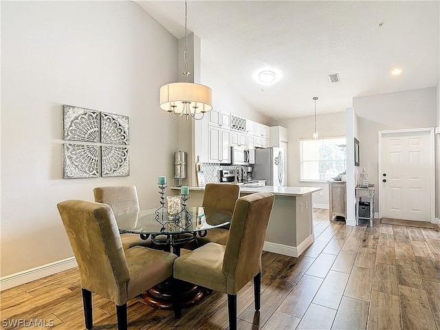 dining room featuring lofted ceiling