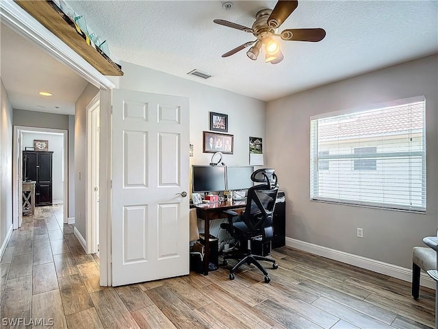 office featuring ceiling fan and a textured ceiling