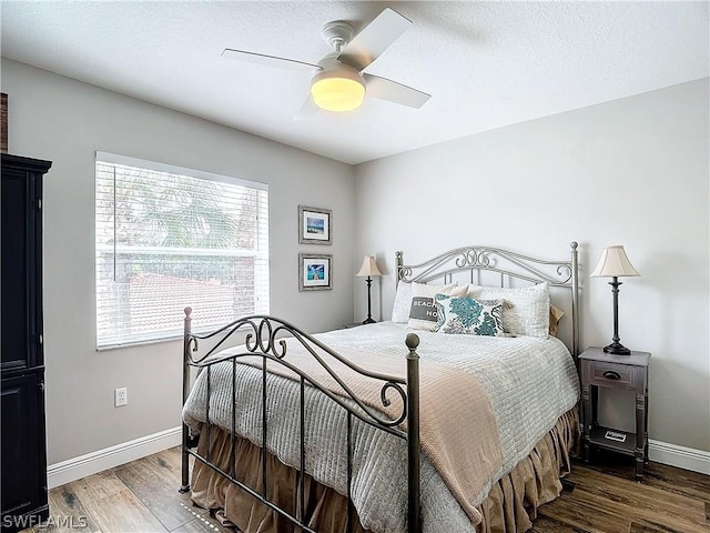 bedroom with ceiling fan and dark wood-type flooring