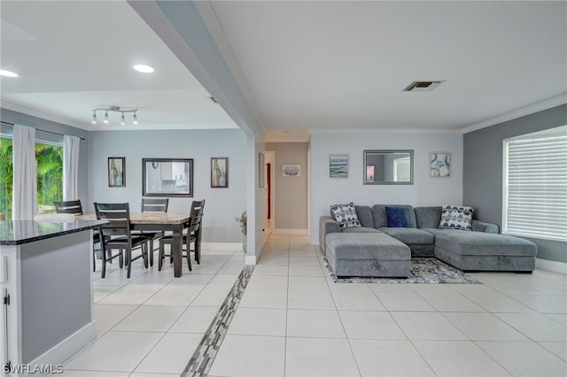 living room featuring crown molding and light tile patterned floors