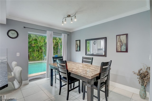 dining area with crown molding and light tile patterned flooring