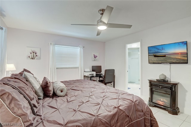 bedroom featuring light tile patterned floors, a spacious closet, and ceiling fan