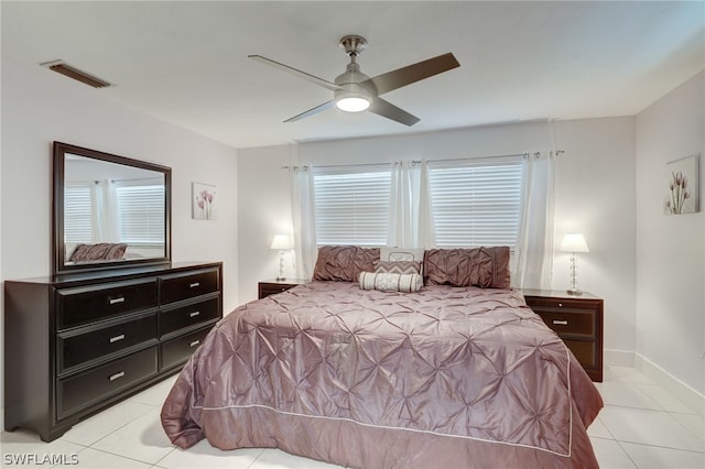 bedroom with ceiling fan and light tile patterned flooring