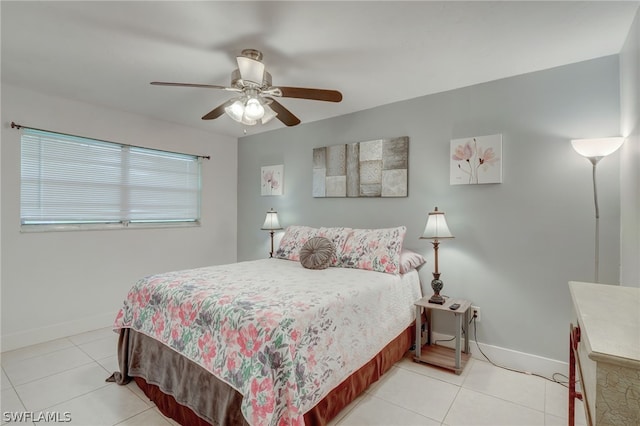 bedroom with ceiling fan and light tile patterned floors