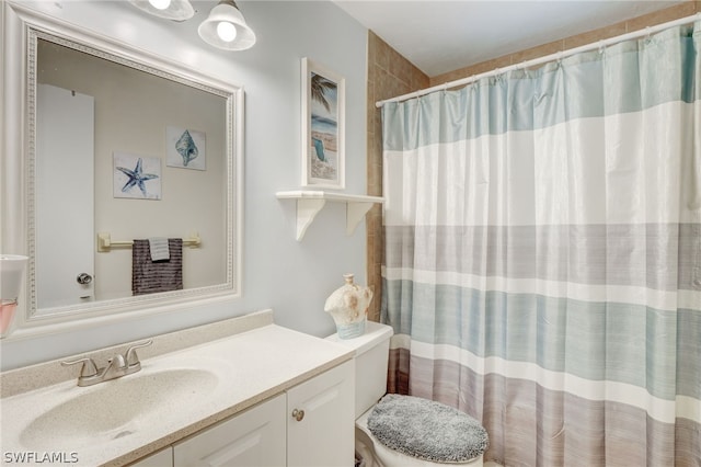 bathroom with vanity, toilet, and curtained shower