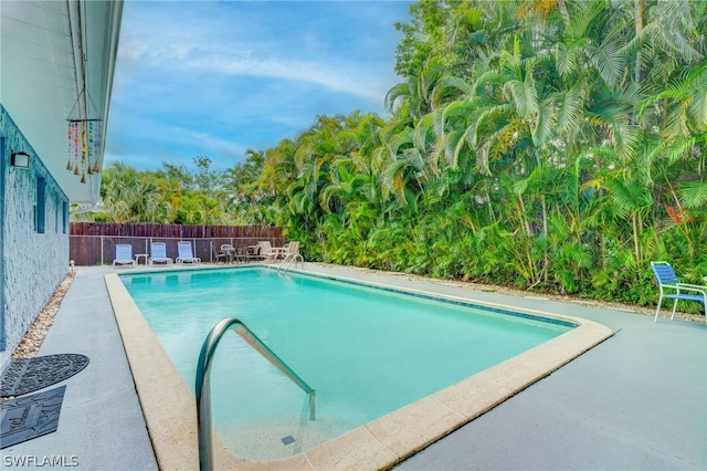 view of swimming pool with a patio area