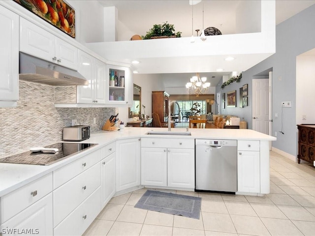 kitchen featuring stainless steel dishwasher, kitchen peninsula, sink, and white cabinets