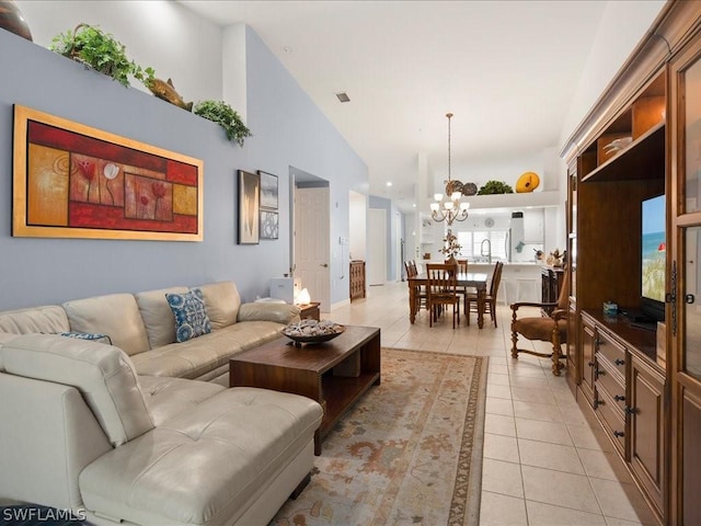 living room featuring an inviting chandelier, light tile patterned floors, and high vaulted ceiling