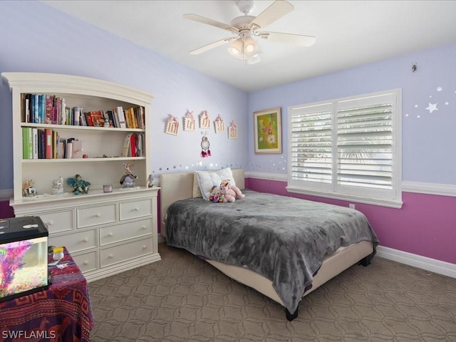 bedroom with dark colored carpet and ceiling fan