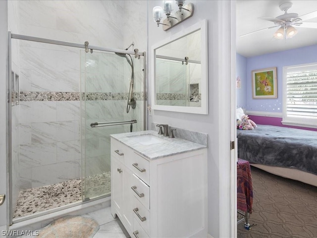 bathroom with ceiling fan, vanity, and a shower with door