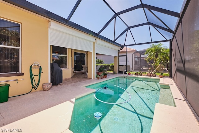 view of pool featuring glass enclosure, a patio, and grilling area